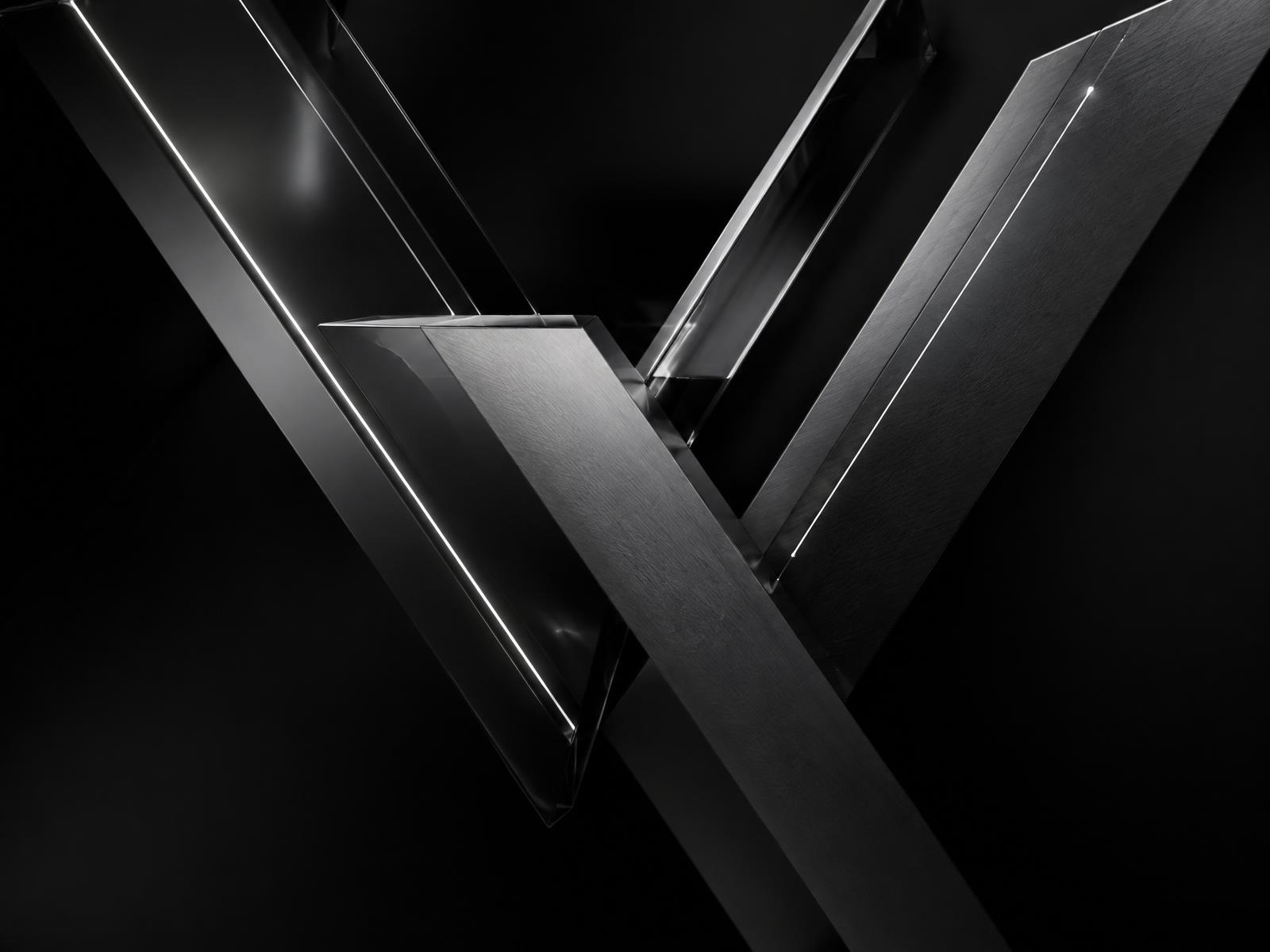 Sculptural V forms in dark metal and glass
